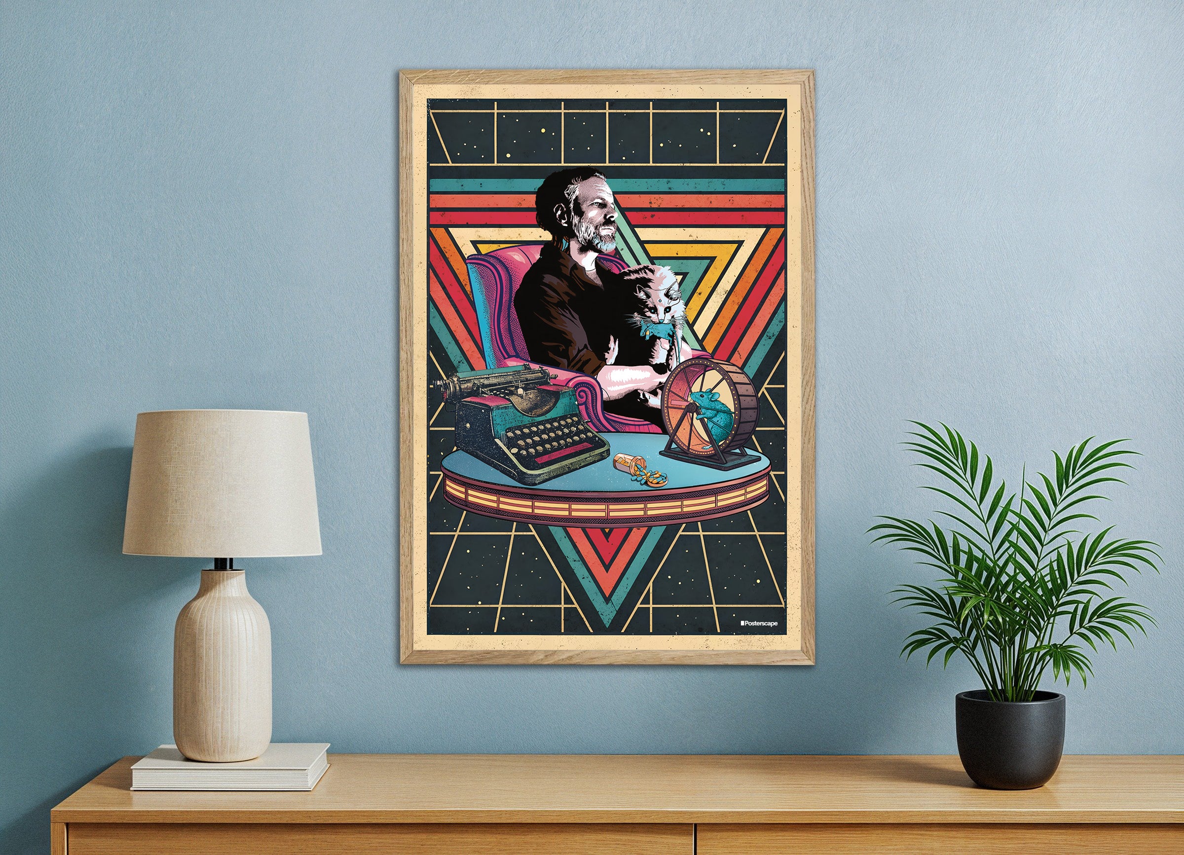 Framed poster of the writer Philip K. Dick with a cat on a typewriter against a blue wall with a lamp and plant.
